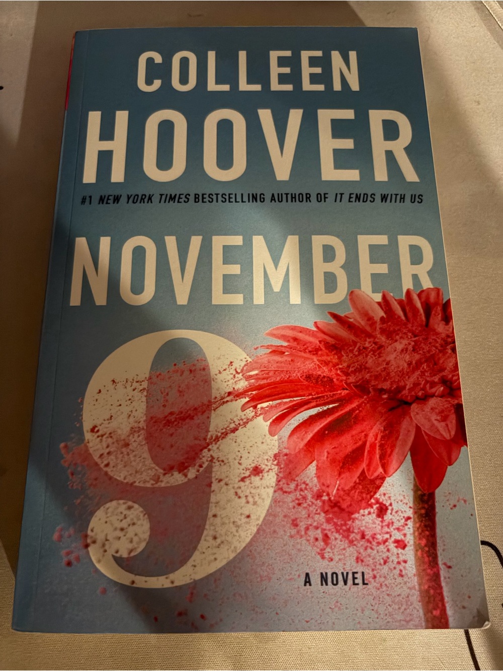 November 9 Paperback Book - Blue Cover with Red Flower
